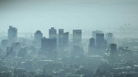 Faint rings popping upper-left causing clear blue disc rotating gliding over hazy city showing data. Orb, holographic, translucent, cyan, urban, skyline, circuits - Powered by Shutterstock - Get 15% off with code: PIKWIZARD15