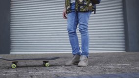 Man tapping board with foot lifting and balancing while red globe timeline overlaying for marketing. Skateboarder, urban, street, sidewalk, shutter, backpack, overcast - Powered by Shutterstock - Get 15% off with code: PIKWIZARD15