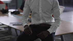 Male professional reacting to blue bubbles rising, shifting posture and smiling in marketing office. Coworker, engagement, metrics, overlays, notifications, tablet, daylight - Powered by Shutterstock - Get 15% off with code: PIKWIZARD15