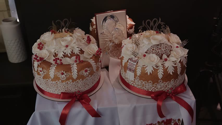 Wedding bread - loaf (cake). Wedding bread. A loaf is decorated with flowers, stables, ears of dough. Wedding. Bride and groom. Ukrainian tradition