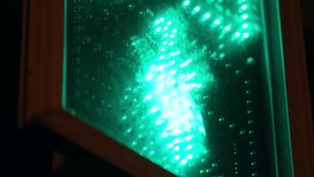 Macro closeup of a glowing green LED matrix behind a translucent panel, revealing segmented patterns, reflections, and circuitry details across an illuminated electronic display. - Powered by Shutterstock - Get 15% off with code: PIKWIZARD15