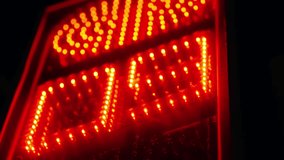 Close-up digital traffic countdown signal changing from red to green, showing LED digits on a pedestrian crosswalk display at night, highlighting urban safety and transition. - Powered by Shutterstock - Get 15% off with code: PIKWIZARD15