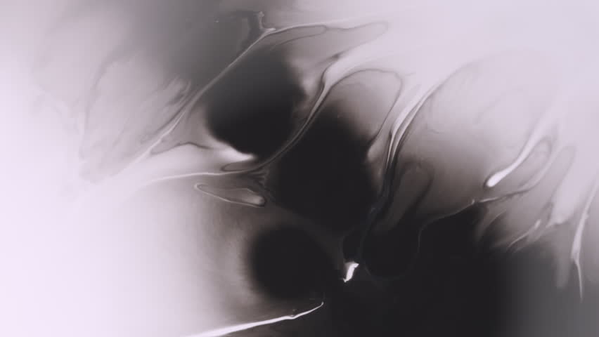 Spatter pigment. Flowing paint. Defocused black white color droplet chemical splash floating on abstract creative acrylic background.