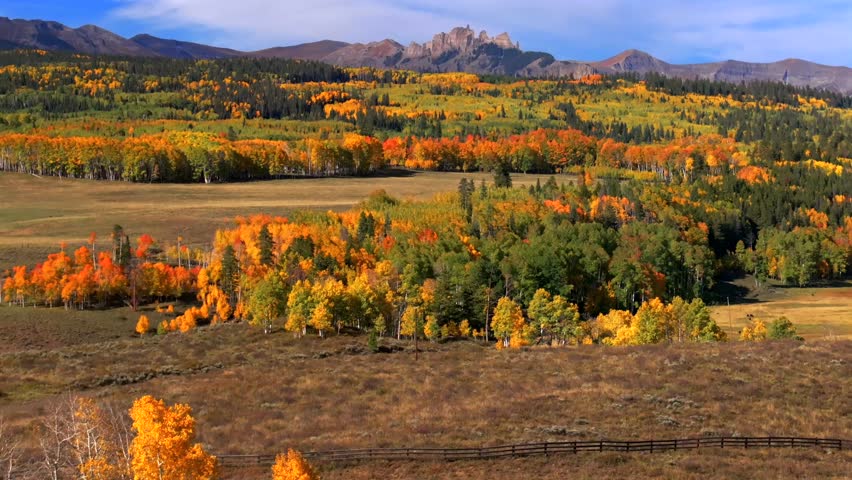 Crested Butte Ohio Kebler Pass Colorado aerial drone parallax The Castle Mountain Mill Castle Gunnison National Forest morning autumn fall Aspen tree colors blue sky clouds farmland forward pan up