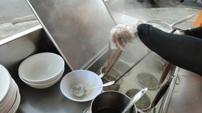 This video shows the process of making wonton noodles, focusing on the seasoning and noodle-boiling stations. Non-halal. the process of boiling noodles. - Powered by Shutterstock - Get 15% off with code: PIKWIZARD15
