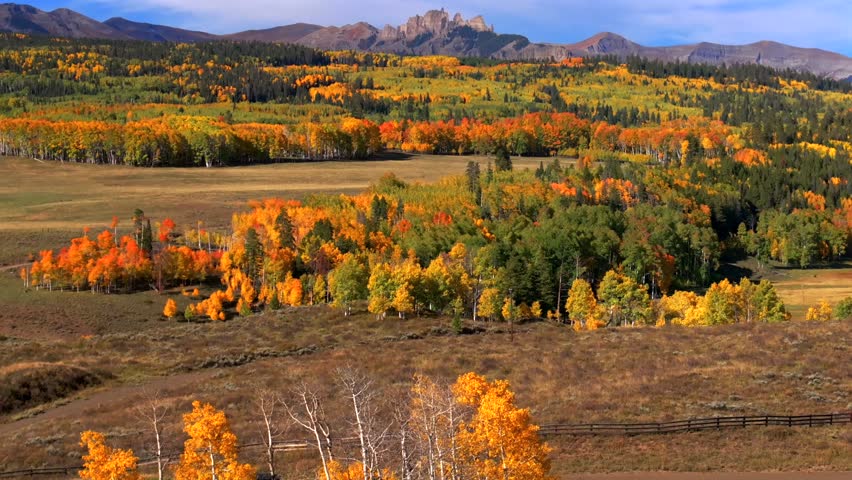 Crested Butte Ohio Kebler Pass Colorado aerial drone The Castle Mountain Mill rock Castle Gunnison National Forest morning autumn fall Aspen tree colors blue sky cloud farmland circle right pan up