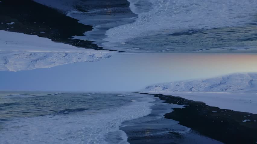 High resolution cinematic beach view with frosty waves crashing against icy shorelines under a soft pastel sky during tranquil twilight. Breathtaking winter seascape scene.