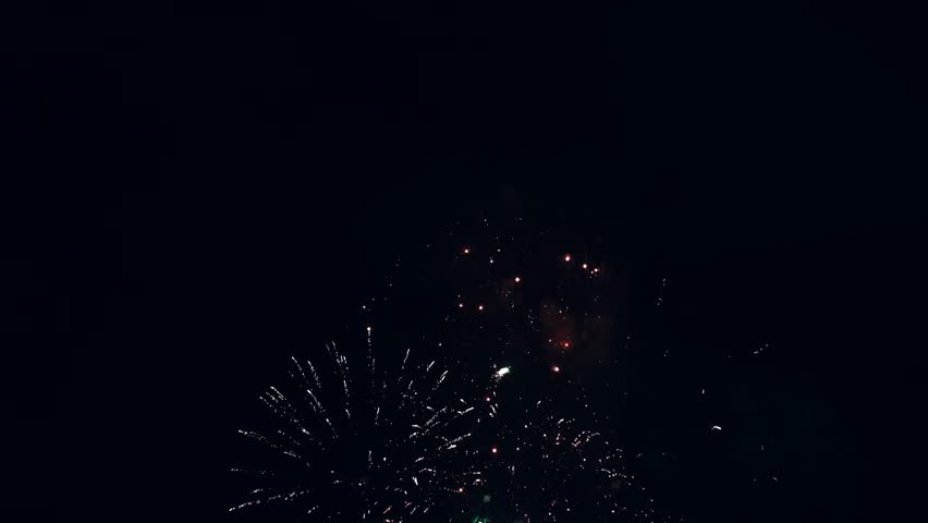 Bright colorful festive glowing fireworks on night sky.  New Year, Christmas, festival, party and holiday celebration concept