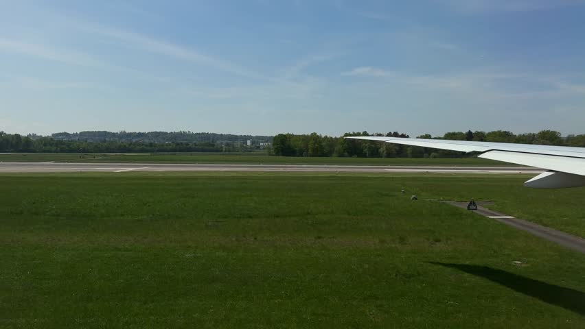 Take-off airplane wing view tarmac markings at Zurich airport Switzerland