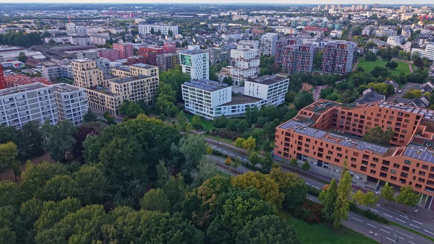 Aerial drone view of modern residential architecture in the La Courrouze eco-district of Rennes, France. Sustainable apartment buildings and green parks characterize this urban development