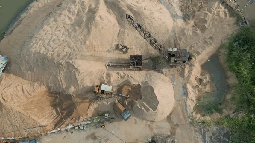 load sand onto the vehicle at sand port in Saigon riverside , Ho Chi Minh City, Vietnam.