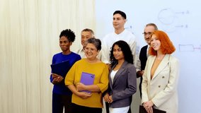 Diverse colleagues celebrate business success in modern office, smiling and cheering by whiteboard. Corporate scene highlights teamwork, leadership, multicultural spirit, and professional unity. 4k - Powered by Shutterstock - Get 15% off with code: PIKWIZARD15