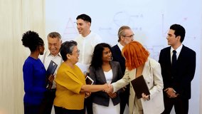 Diverse colleagues celebrate business success in modern office, smiling and cheering by whiteboard. Corporate scene highlights teamwork, leadership, multicultural spirit, and professional unity. 4k - Powered by Shutterstock - Get 15% off with code: PIKWIZARD15