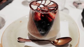 Elegant dessert in a glass topped with fresh strawberries, blueberries, and a chocolate lattice decoration - Powered by Shutterstock - Get 15% off with code: PIKWIZARD15