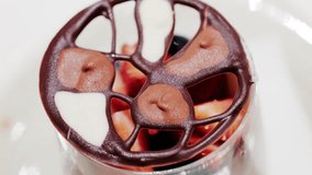 Elegant dessert in a glass topped with fresh strawberries, blueberries, and a chocolate lattice decoration - Powered by Shutterstock - Get 15% off with code: PIKWIZARD15