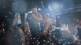 Singer singing music under lights, camera pushing crowd, hands raising red cups clinking toasting. Concert, audience, stage, spotlight, confetti, bokeh, energy - Powered by Shutterstock - Get 15% off with code: PIKWIZARD15