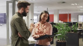 Woman showing folder to marketer reviewing content, bubbles floating around them updating likes. Office, collaboration, teamwork, analytics, engagement, metrics, presentation - Powered by Shutterstock - Get 15% off with code: PIKWIZARD15