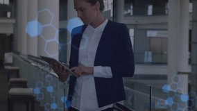 Female pro tapping tablet by railing, starting tech overlays of code, hexagon and DNA helix reading. Professional, executive, business, technology, modern, atrium, glass - Powered by Shutterstock - Get 15% off with code: PIKWIZARD15