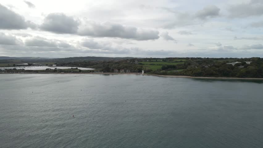 Aerial view of St Helens village named in dedication to St Helena Church, a destroyed church built in the 12th century, Cluniac priory. Only the tower of the church remains, drone going forward.