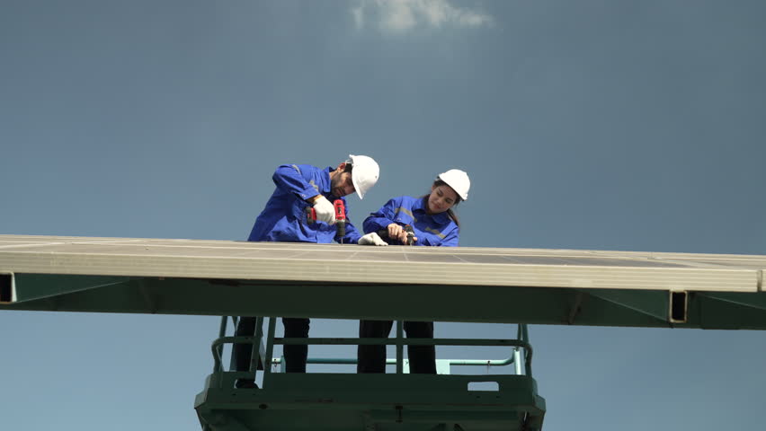 Engineers are working at solar farm. Electricity, sustainability.