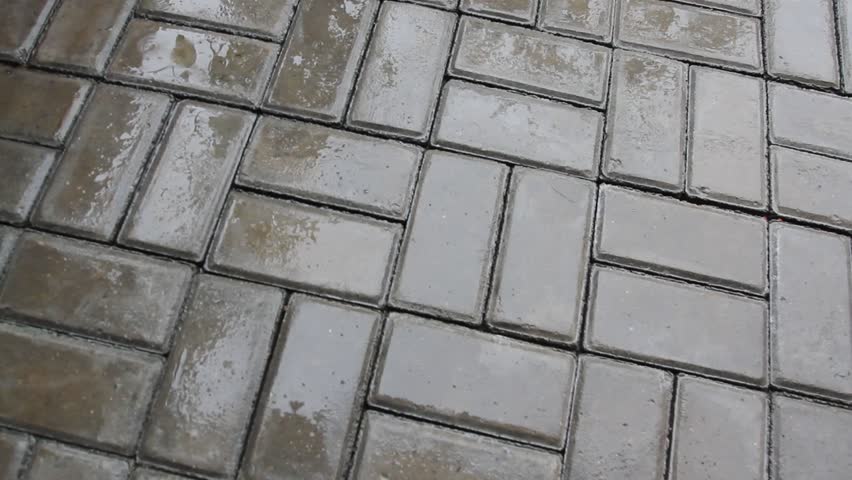Wet concrete pavement surface when it rains.