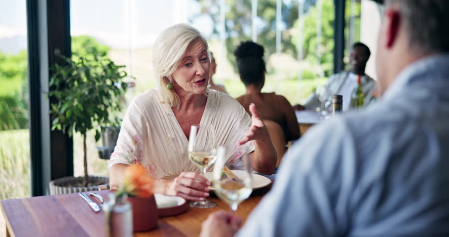 Mature couple, wine tasting and restaurant with date for romantic meal or cuisine in vineyard venue. Man, woman or customer with alcohol for eating, fine dining or anniversary together in diner