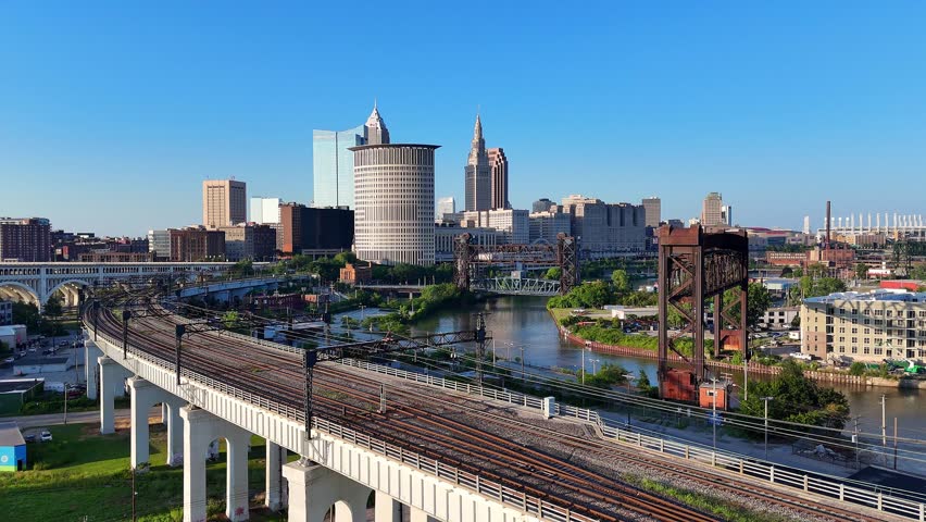 Downtown Cleveland with rail tracks in Irishtown Bend Neighborhood over Cuyahoga River, USA