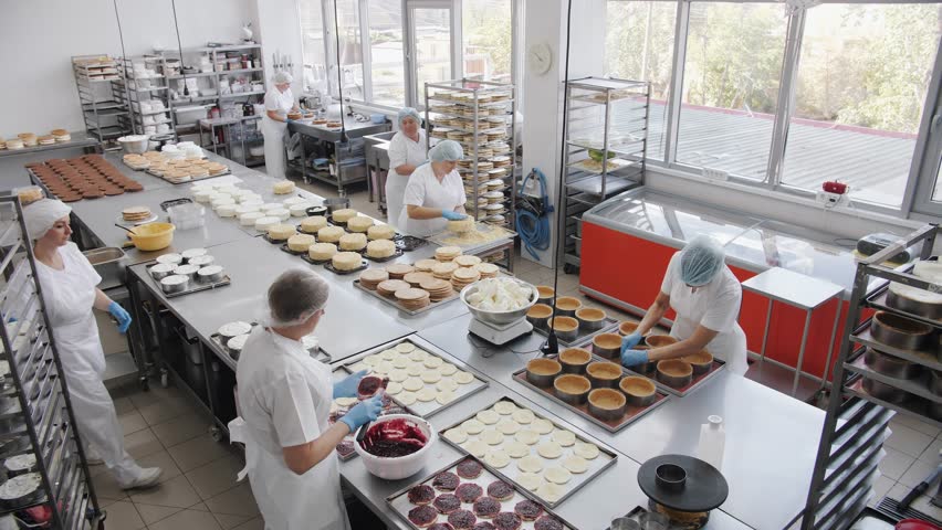 Bakery teamwork preparation. Industrial bakery workers 