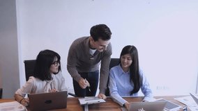 A team collaborates during a meeting as a colleague points to a chart while explaining ideas. The two women listen and review the information, creating a focused, supportive, and productive business environment. - Powered by Shutterstock - Get 15% off with code: PIKWIZARD15