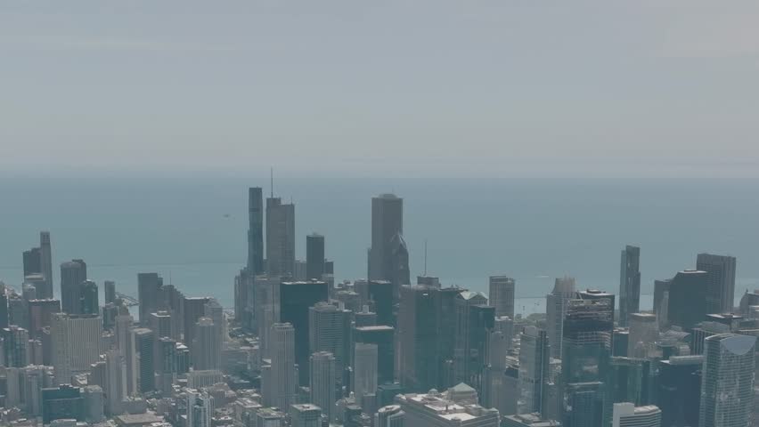 The skyline of Chicago showcases tall buildings and modern architecture, overlooking the vastness of Lake Michigan on a clear day, reflecting vibrant urban life.