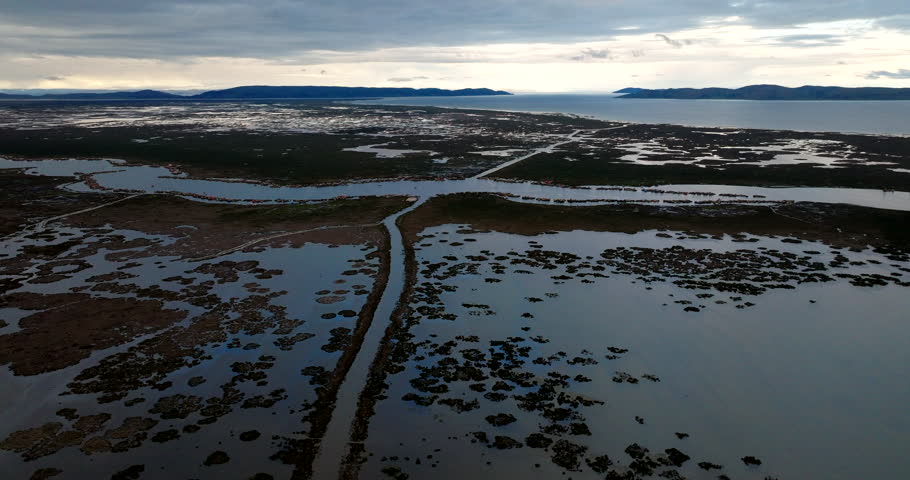 Navigable waterway on lake Titicaca leading toward Uros floating islands, aerial