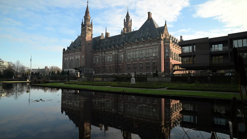 Reflection of a beautiful Peace Palace building and most visited building in The Hague and seat of the International Court of Justice at Autumn season