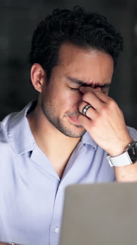 Night, tired and business man with eye strain, pressure or exhausted journalist with laptop. Computer, stress and person with deadline at work, visual fatigue or reporter with burnout in office