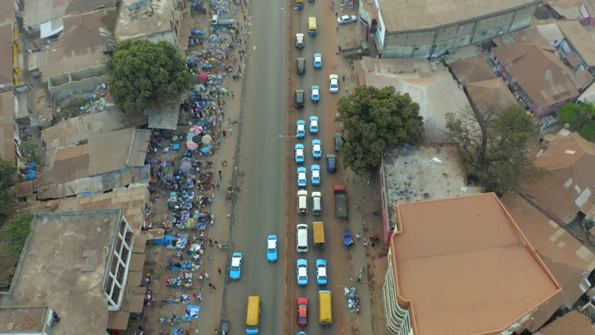 Street View of African Town with Traffic Congestion and Shops
