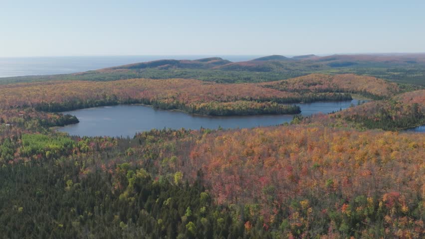 Aerial View of Lake Agnes Surrounded by Vibrant Fall Forest in Lutsen Minnesota