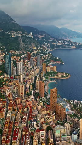 Birds eye aerial view of traffic in Monte Carlo, Monaco. Famous formula one Grand Prix Circuit. Aerial view of the city of Monaco. Establishing shot showcases luxury yachts moored in Monaco bay