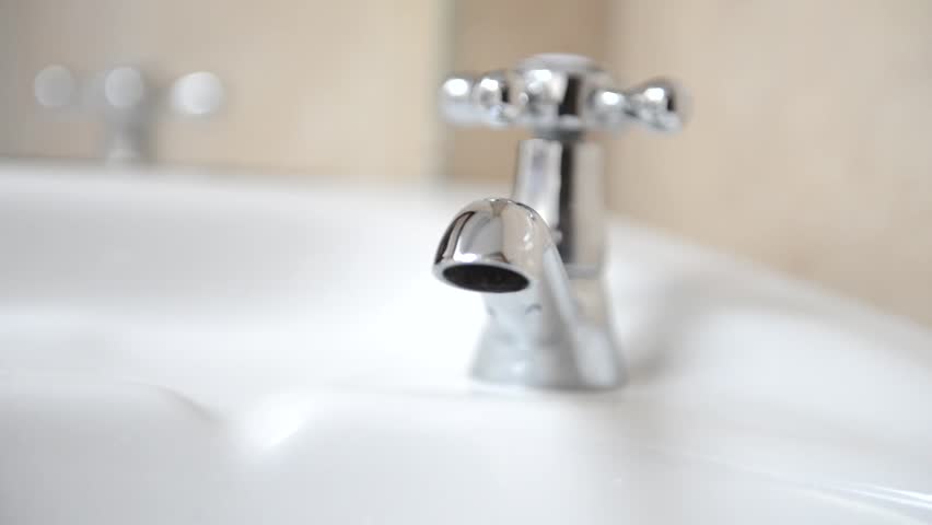 Running Water, close up of adult hand turning on and off bathroom faucet Royalty-Free Stock Footage #3953711