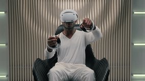 African American man in VR helmet holding controllers using virtual reality in futuristic space metaverse technology gamer guy male playing game driving car futurism innovation simulation interface - Powered by Shutterstock - Get 15% off with code: PIKWIZARD15