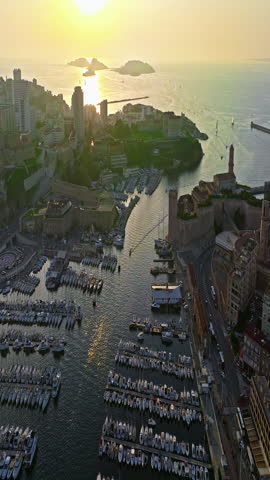  Many boats and yachts are parked in the city marina. Aerial view of the port of Marseille in the morning sun. Drone view of Marseille in the south of France