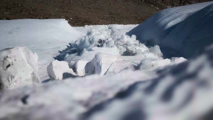 Amazing Antarctica mountains winter landscape. Green rock hill, frozen ocean, ice snow covered island glacier in background. Antarctic wild nature travel exploration. Tourism expedition to South Pole