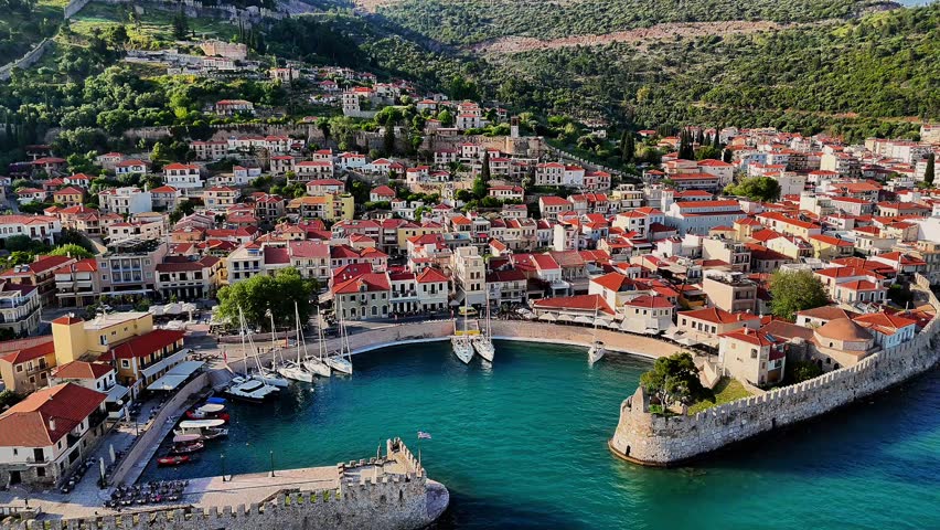 Aerial drone footage capturing the Venetian Harbour of Nafpaktos, Greece, with its iconic circular port, stone walls, and entrance towers. 