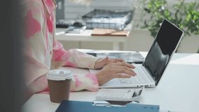 Two financial accountants analysing business spreadsheets on laptop computer, sitting at office desk, looking through paper documents, using calculator working with databases, checking excel tables - Powered by Shutterstock - Get 15% off with code: PIKWIZARD15