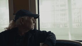 Old Man Watches Out of the Window as the Train Moves Travelling - Powered by Shutterstock - Get 15% off with code: PIKWIZARD15