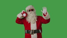Santa Claus dancing cheerfully with a portable speaker on a green chroma key background - Powered by Shutterstock - Get 15% off with code: PIKWIZARD15