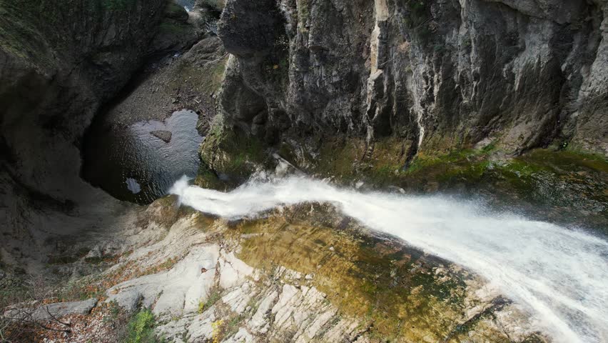 Waterfall footage 4k aerial. Natural landscape with a waterfall. Waterfall background closeup.