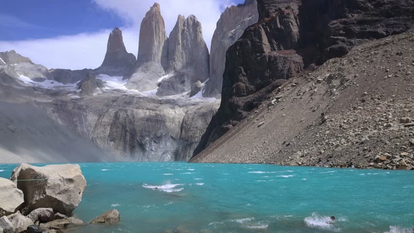 Torres del Paine mountain landscape with granite peaks, rugged terrain, dramatic skyline, Patagonia nature scenery, travel background, outdoor environment, wilderness view captured in video footage