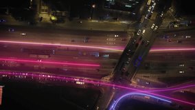 Overhead shot of urban freeway traffic at night, enhanced with glowing digital lines representing data, connectivity, and the flow of information in a futuristic smart city - Powered by Shutterstock - Get 15% off with code: PIKWIZARD15