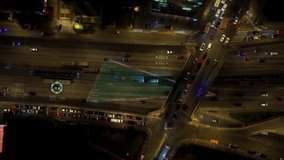 Overhead shot of urban traffic moving on a multi lane highway at night, enhanced with futuristic digital graphics illustrating an intelligent transportation network and real time data analysis - Powered by Shutterstock - Get 15% off with code: PIKWIZARD15
