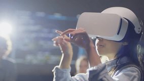 Close-up of an elementary-age Hispanic girl wearing VR goggles in a classroom, exploring an interactive virtual experience and engaging with modern educational technology. - Powered by Shutterstock - Get 15% off with code: PIKWIZARD15