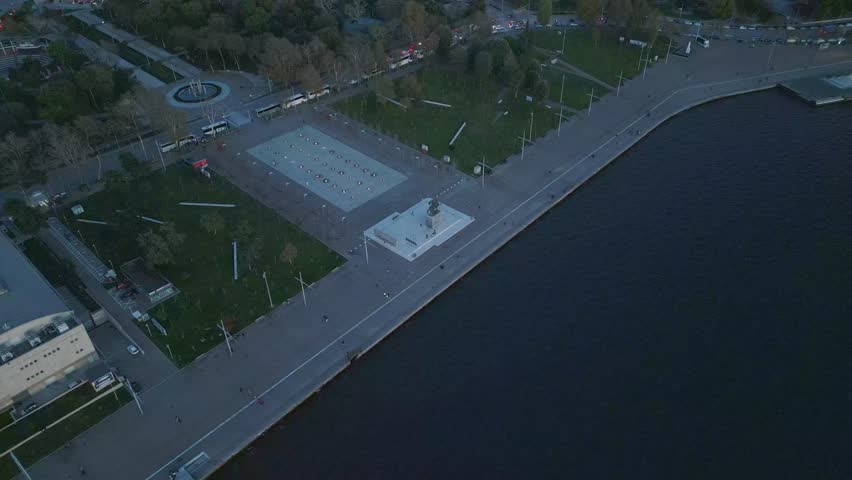 Aerial drone shot of the Alexander the Great statue on the Thessaloniki waterfront, Greece. The iconic monument and surrounding promenade are captured from above, highlighting urban coastal scenery